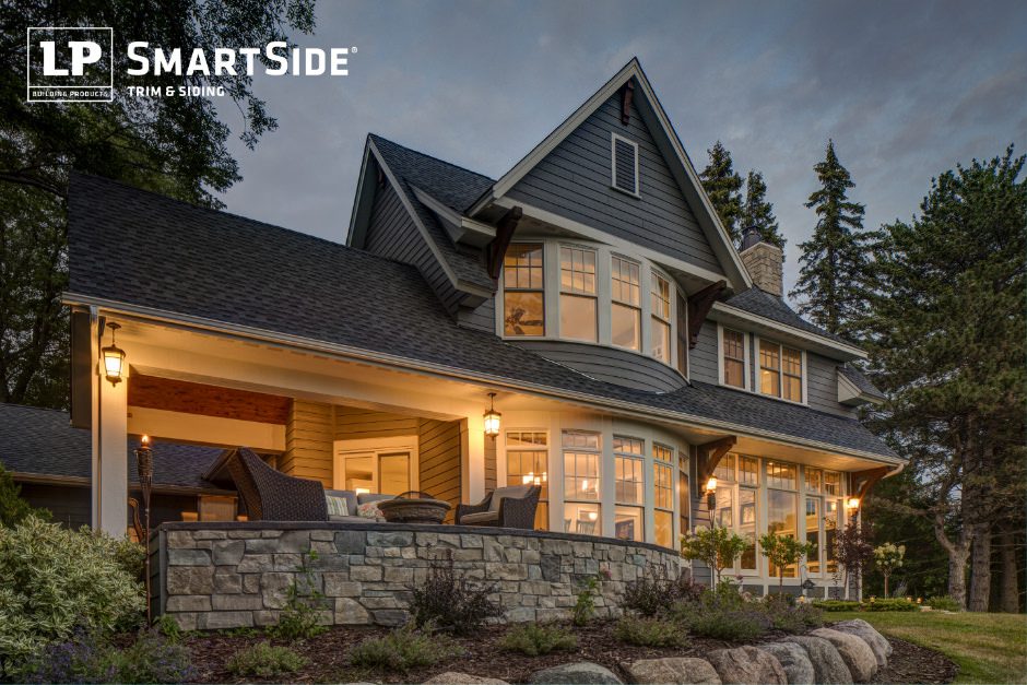 lpc_28890974719 Large home lit up at dusk featuring LP SmartSide trim and siding